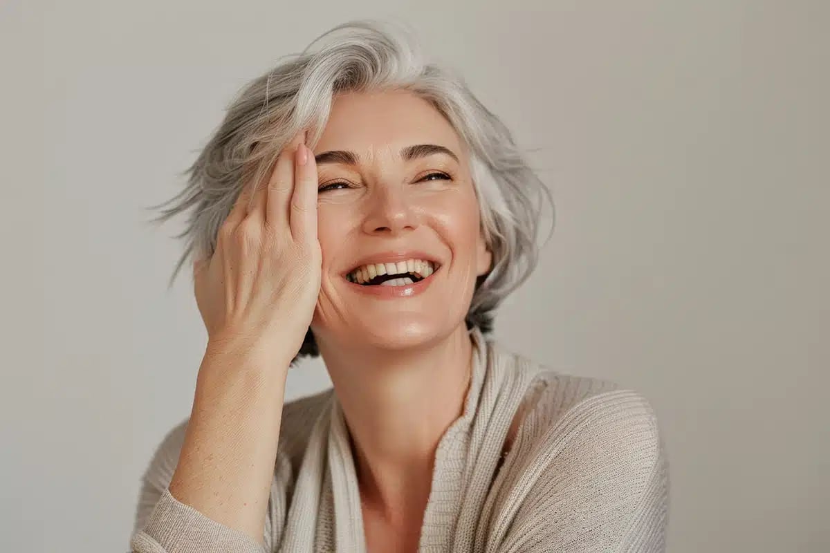 Beautiful face and smiling mature woman with shining anti-aging cosmetics and dermatology