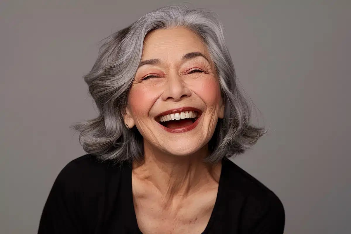 Beautiful gorgeous 50s mid age beautiful elderly senior model woman with grey hair laughing and smiling Beautiful gorgeous 50s mid age beautiful elderly senior model woman with grey hair laughing and smiling