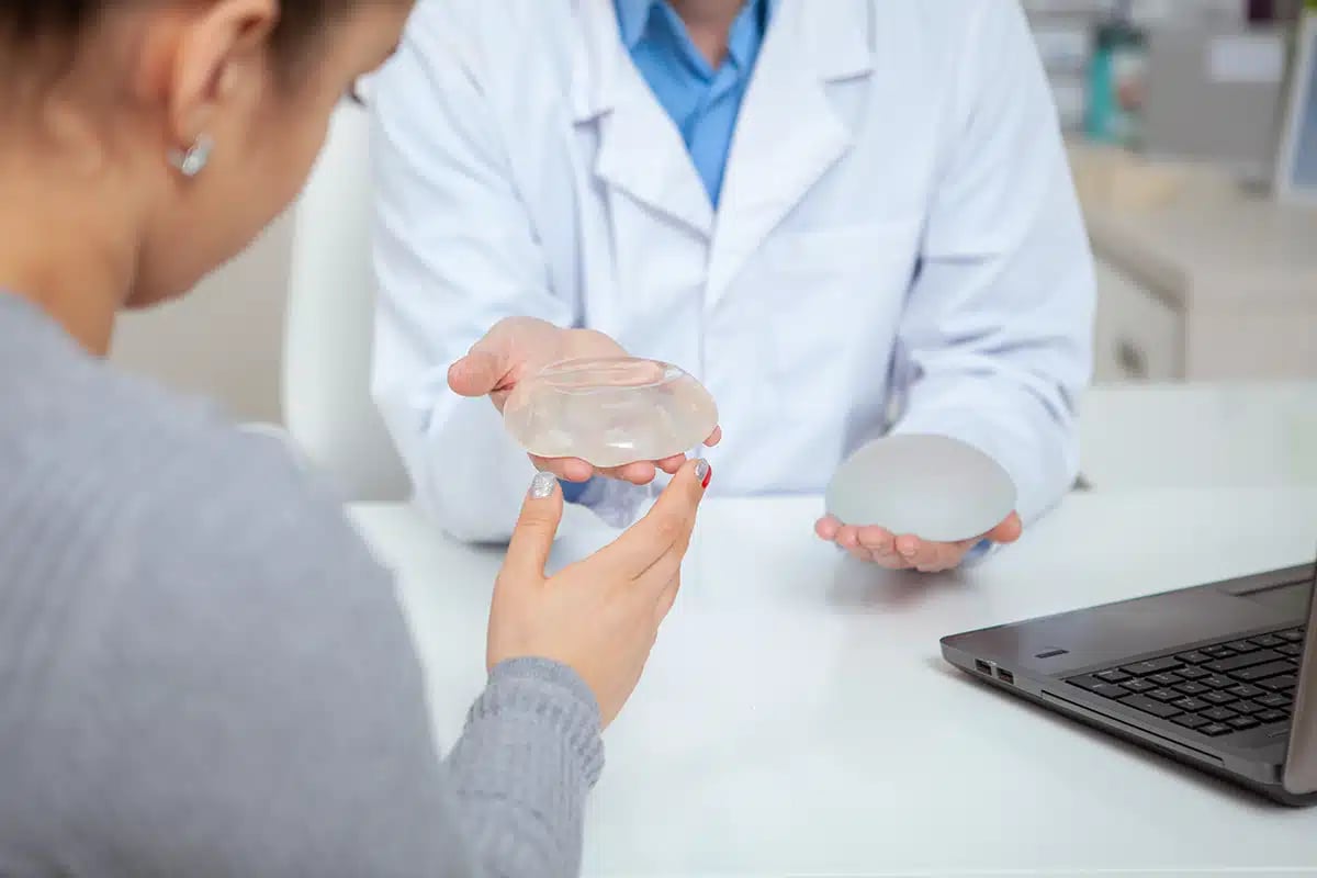 Cropped shot of a female patient examining silicone breast implants