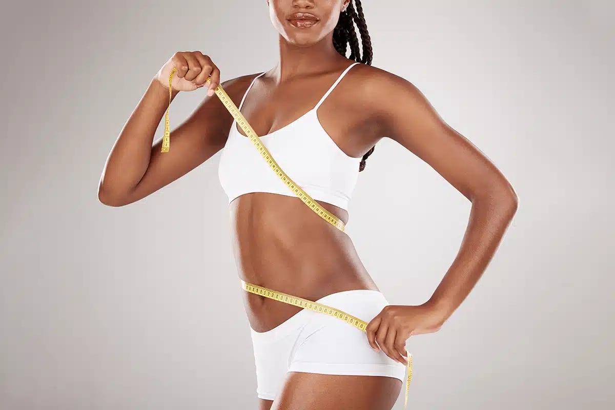 Diet, tape measure and stomach or body of woman for health and wellness