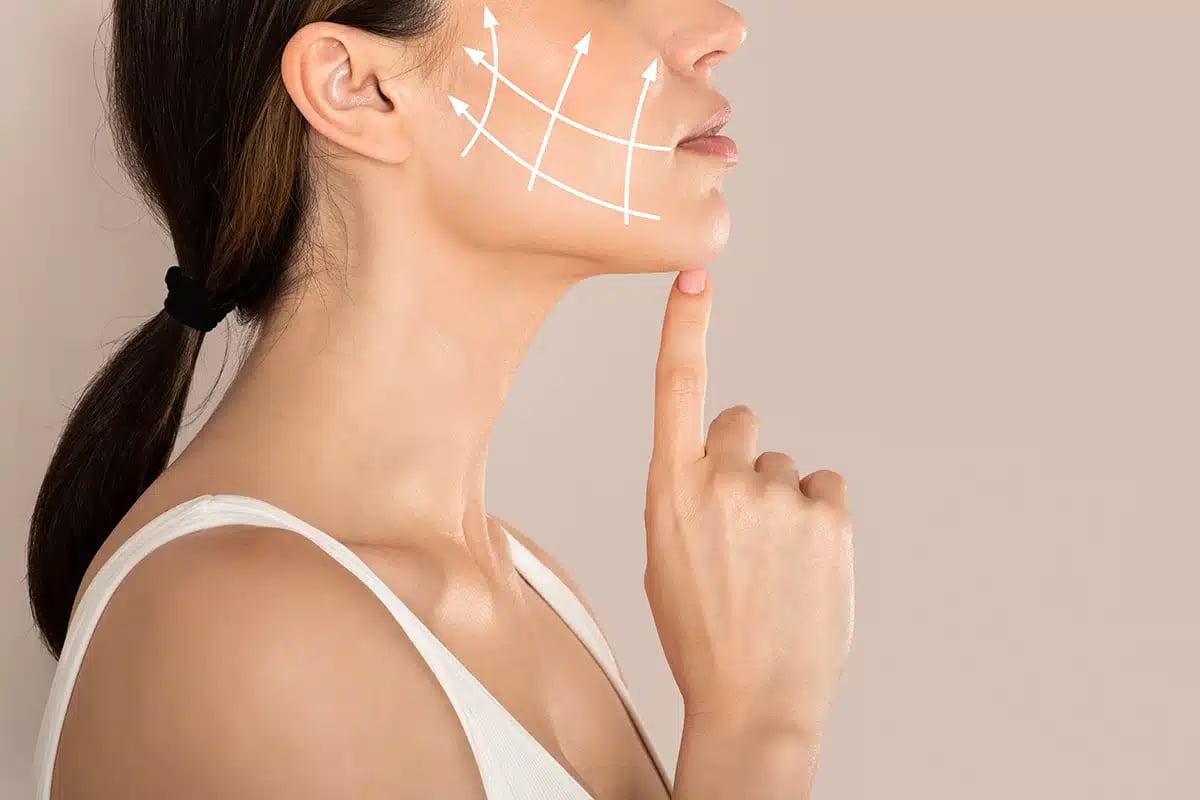 Side view of unrecognizable lady with lifting arrows on cheek Side view of unrecognizable lady with lifting arrows on cheek