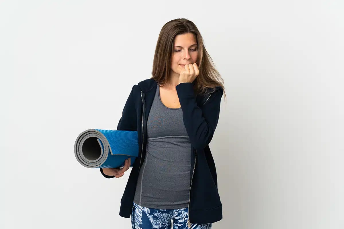 A woman going to yoga classes having doubts