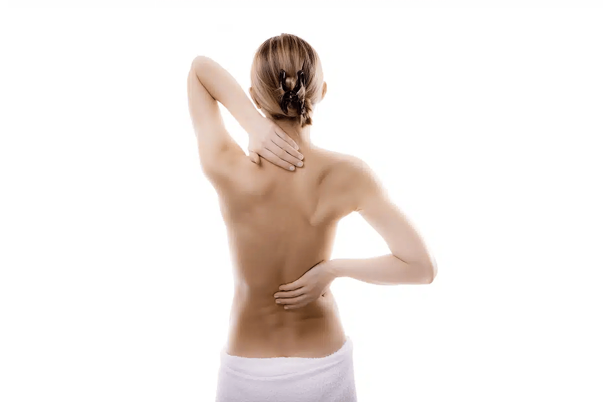 Woman massaging shoulder and back pain